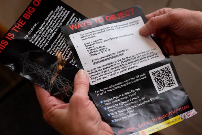 Angela Taylor holds campaign leaflets detailing ways to object to pylons, including a QR code for an AI-powered objection letter site.