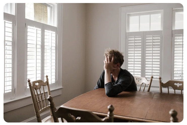 man sitting at table from post How to Rewire Your Anxious Brain