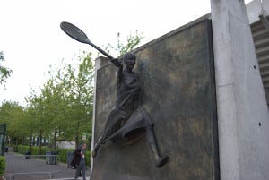 Statue of Suzanne Lenglen, outside the show court named for her. She won 31 championships in the 1930s and was the first female tennis celebrity. Statue of Suzanne Lenglen, outside the show court named for her. She won 31 championships in the 1930s and was the first female tennis celebrity.