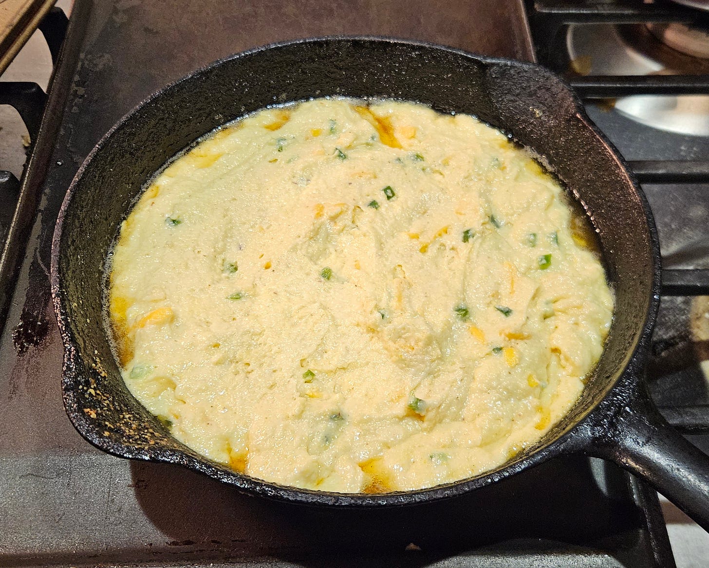 corn bread batter in a cast iron frying pan