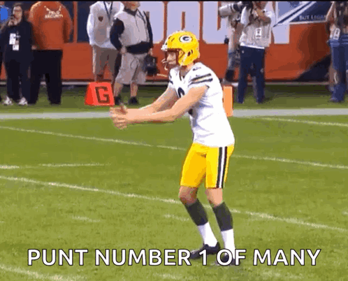 a football player is standing on a field with the words punt number 1 of many written below him .