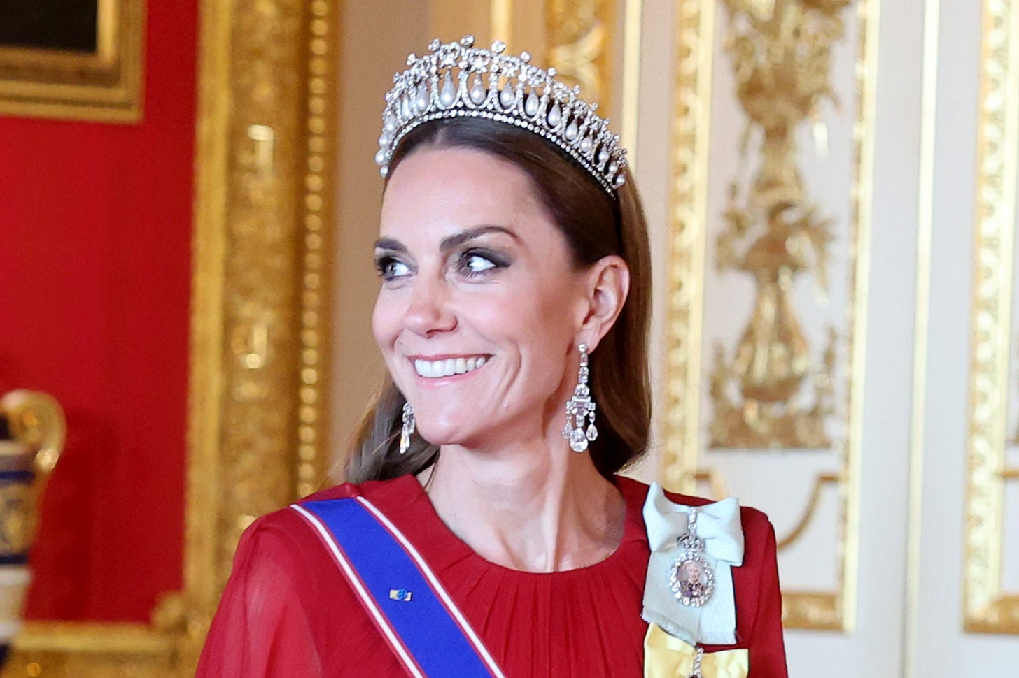 Princess of Wales smiling in red gown and tiara