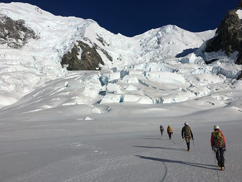 Images of the Himalayas and Alan crossing a glacier, and suspended down a crevasse