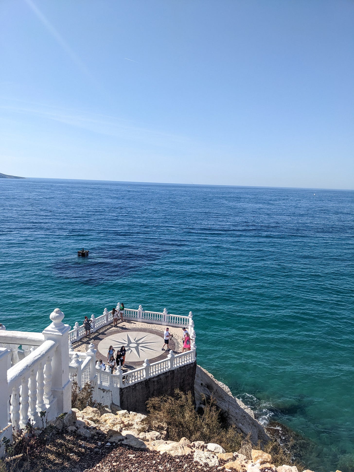 a hexagaonal viewpoint surrounded by a white balustrade over the blue Mediterranean a hexagaonal viewpoint surrounded by a white balustrade over the blue Mediterranean