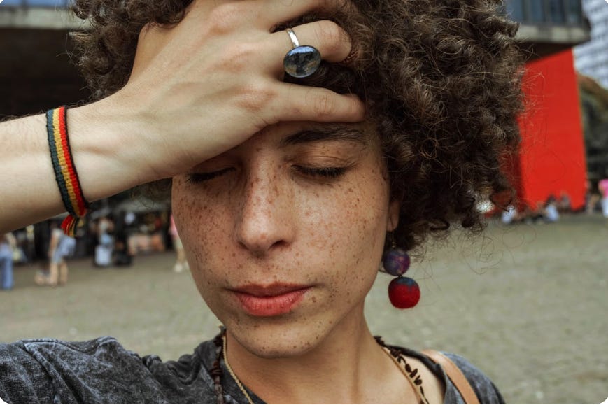 a person with hand over their head looking stressed