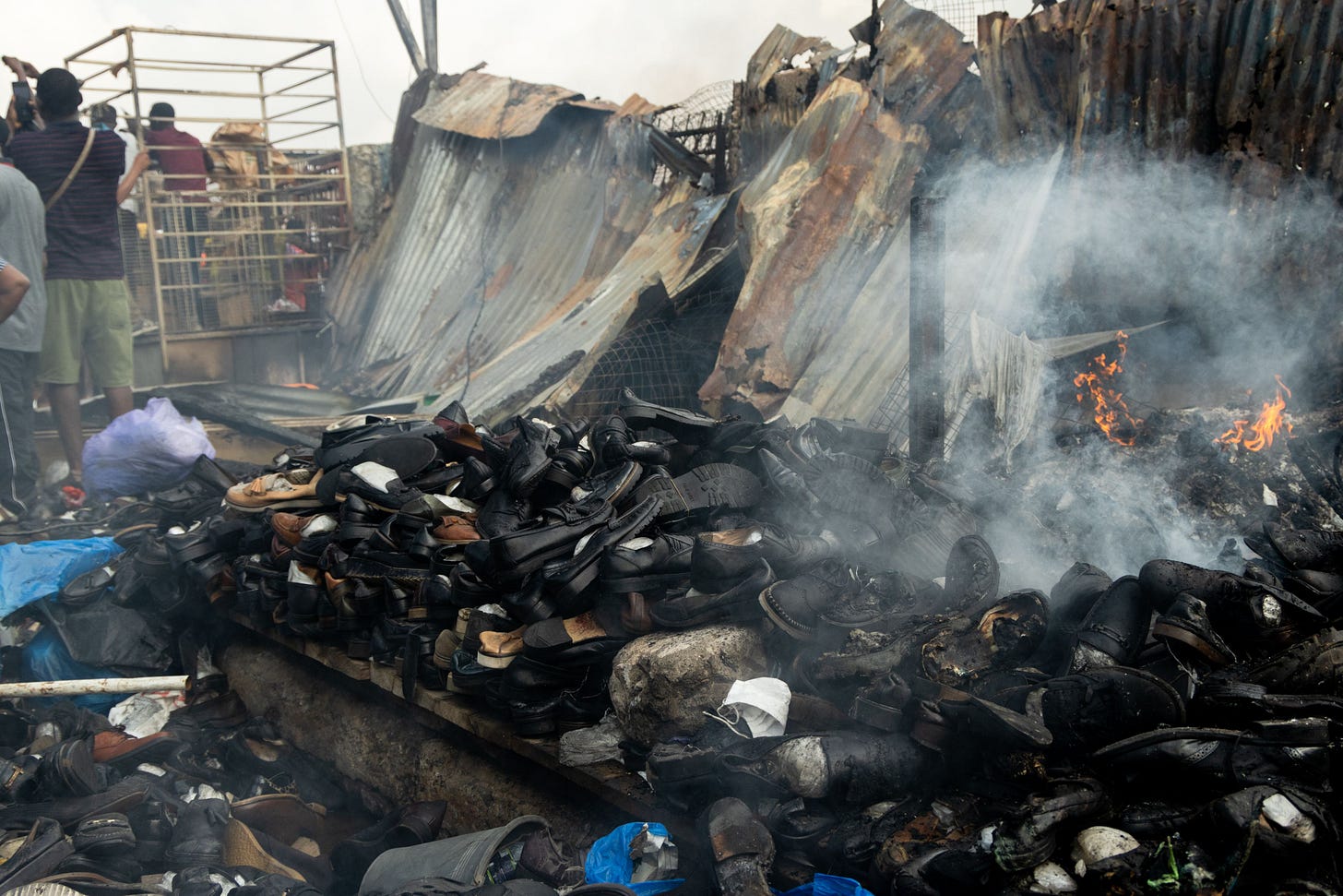 Some piles of shoes at the shoe lane in the Kantamanto market during the fire_photographed by Tonia-Marie Parker_The Or Foundation.jpg Some piles of shoes at the shoe lane in the Kantamanto market during the fire_photographed by Tonia-Marie Parker_The Or Foundation.jpg