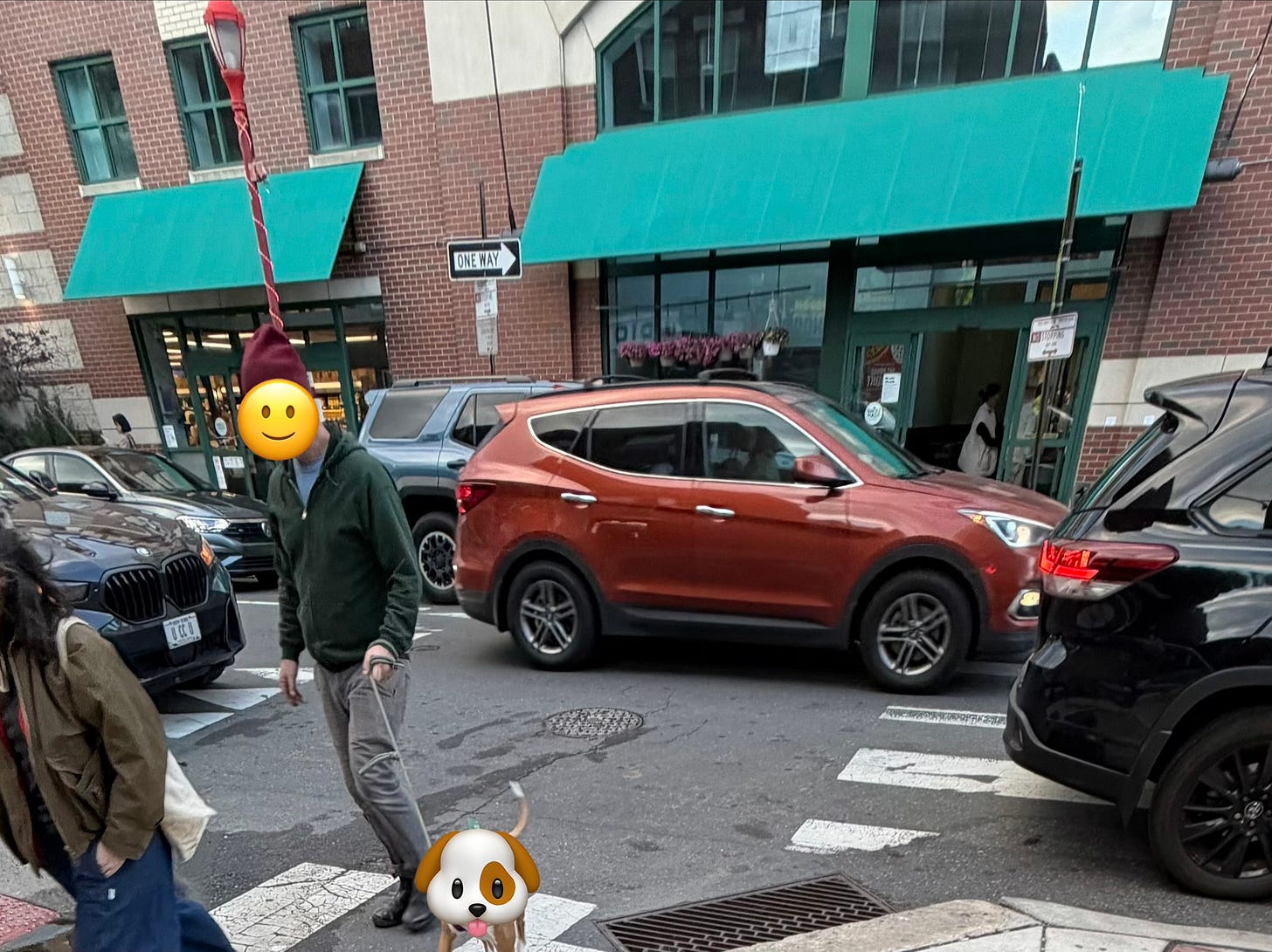 A picture of the Whole Foods on South St from across the street. Cars are parked in front of hydrants, covering crosswalks, in no-stopping zones, etc.