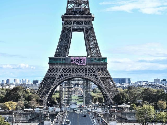 Climate activists hang signs reading “Rebel” off the Eiffel Tower Climate activists hang signs reading “Rebel” off the Eiffel Tower