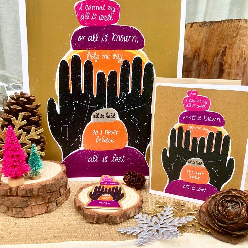 All is Held products from Cobbleworks - a large print, a card, and a sticker, each with the same phrase in script with black hand illustrations covered in constellations