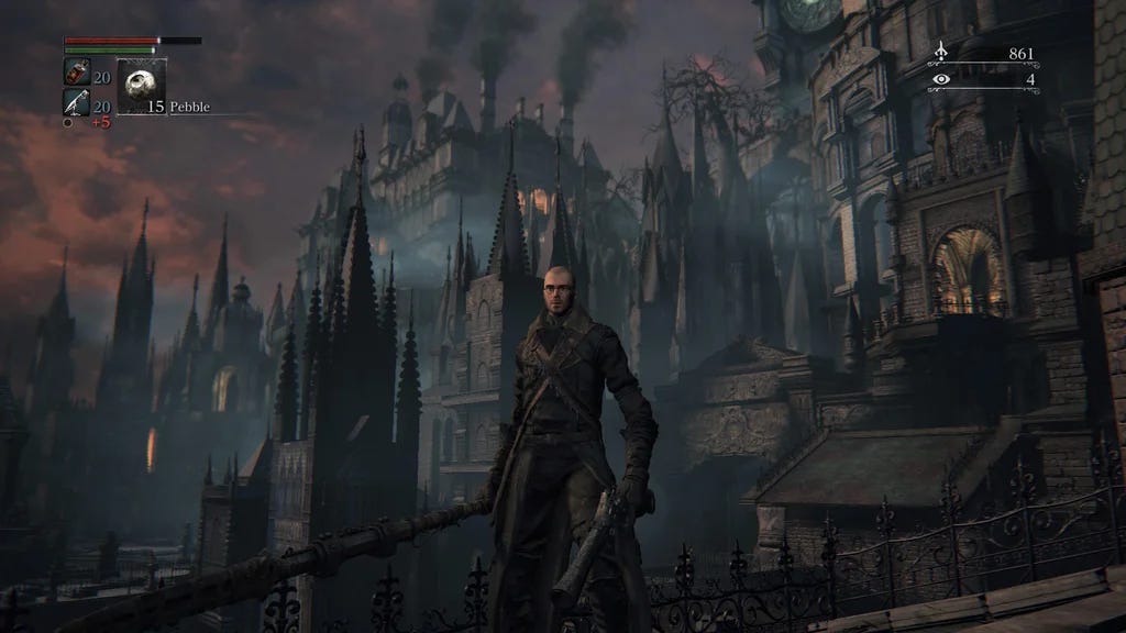 A screenshot from Bloodborne, with the player character in the foreground and the camera showing a building far in the distance billowing smoke from chimeys on the roof.