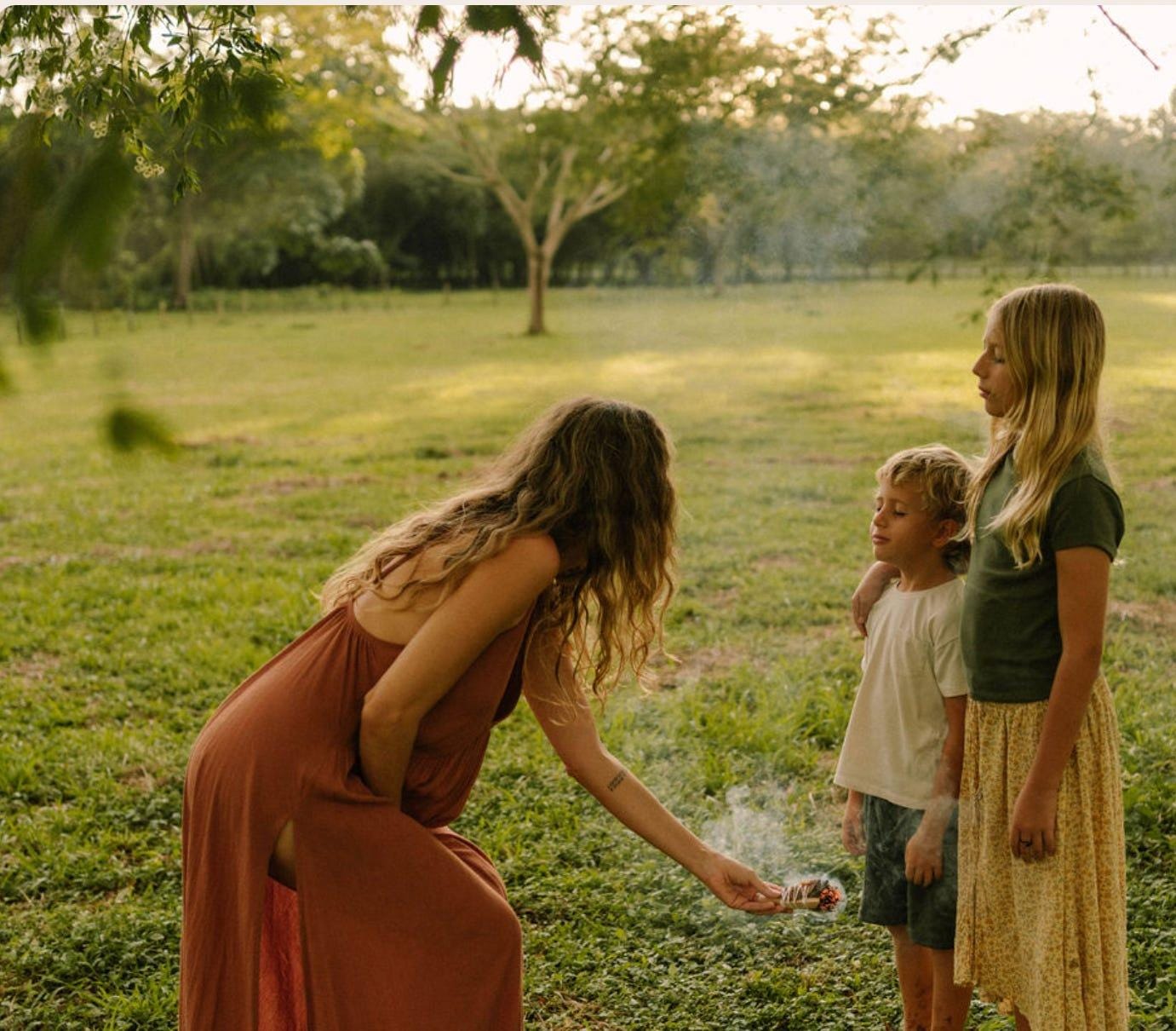 A person and two children outside

Description automatically generated