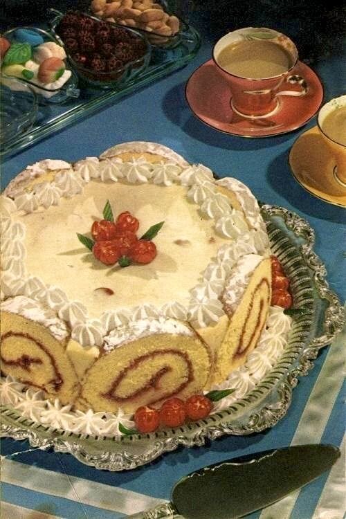 This may contain: there is a cake on the table with plates and spoons next to it,