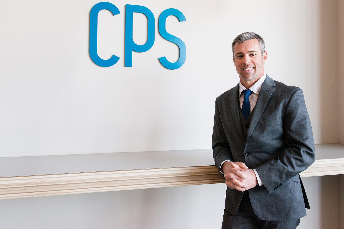 A photo of John Estin Davis posing in front of a wall with the Comprehensive Pain Specialists logo on it. A photo of John Estin Davis posing in front of a wall with the Comprehensive Pain Specialists logo on it.