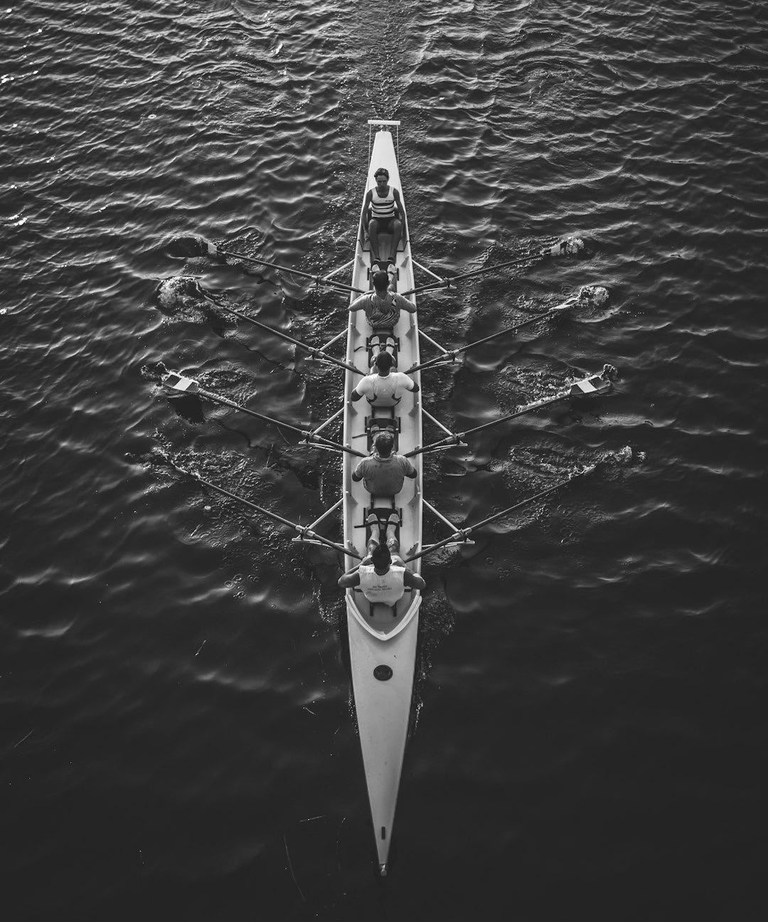 people riding boat on body of water