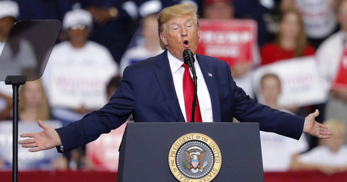 A person in a suit and tie speaking into a microphone

Description automatically generated with medium confidence