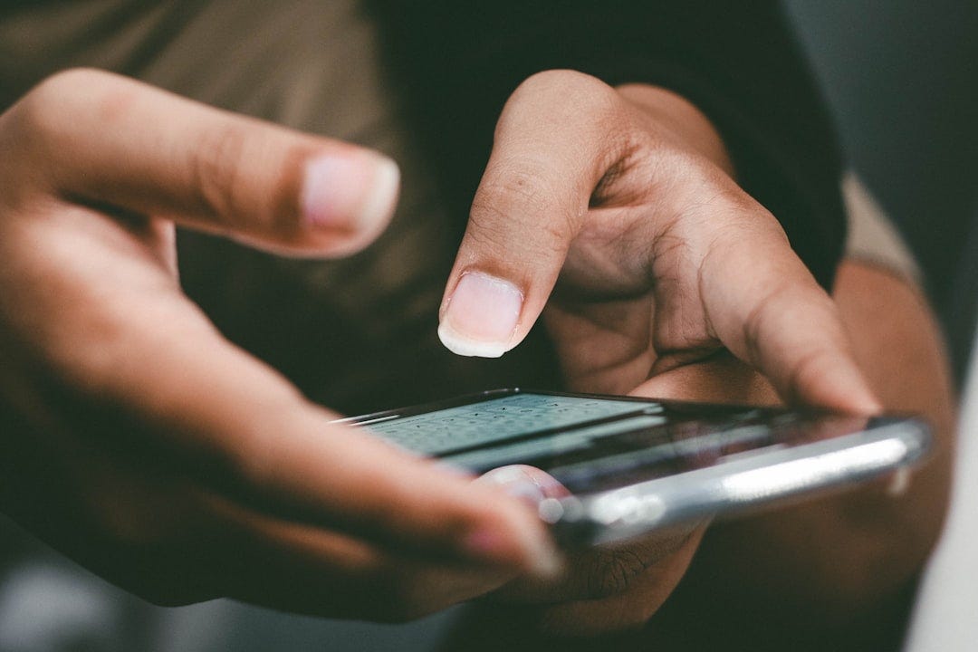 a close up of a person holding a cell phone a close up of a person holding a cell phone