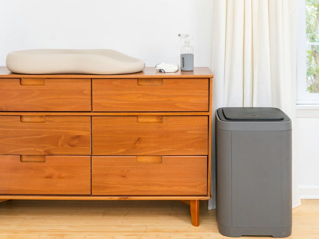 a room with a dresser and a window a room with a dresser and a window