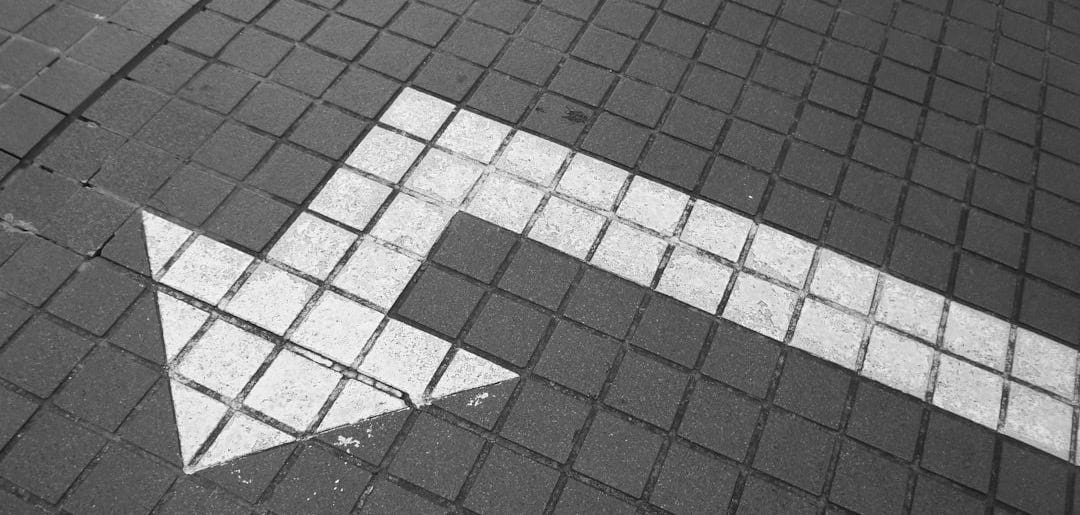 white arrow on bricked pavement white arrow on bricked pavement