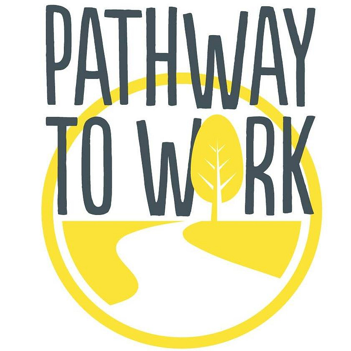 A young man writing on a worksheet at a table next to the Pathway to Work logo