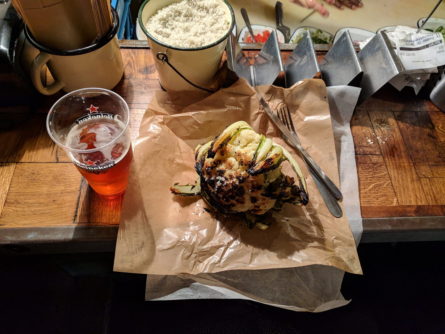 charred cauliflower and bucket of salt
