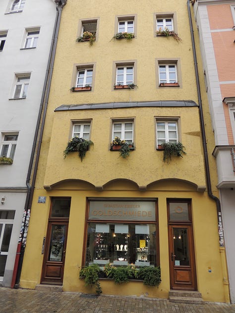 photos of buildings, a cathedral. a plaque, and a gravestone embedded in a wall