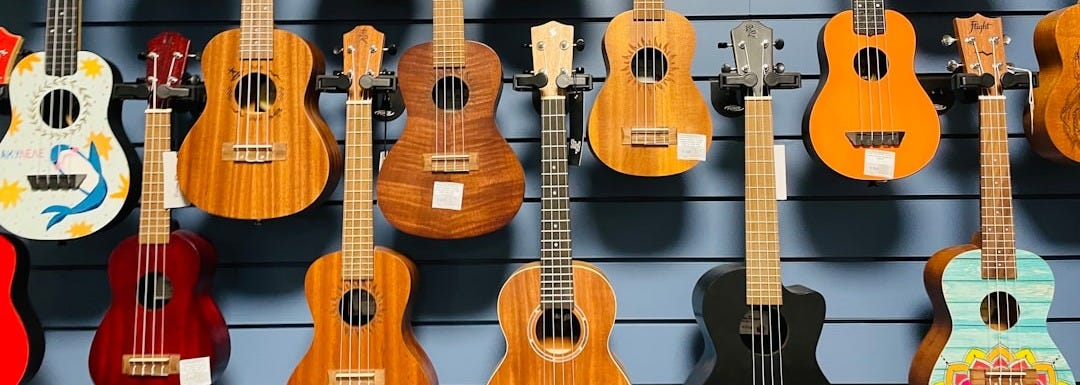 a display of guitars hanging on a wall