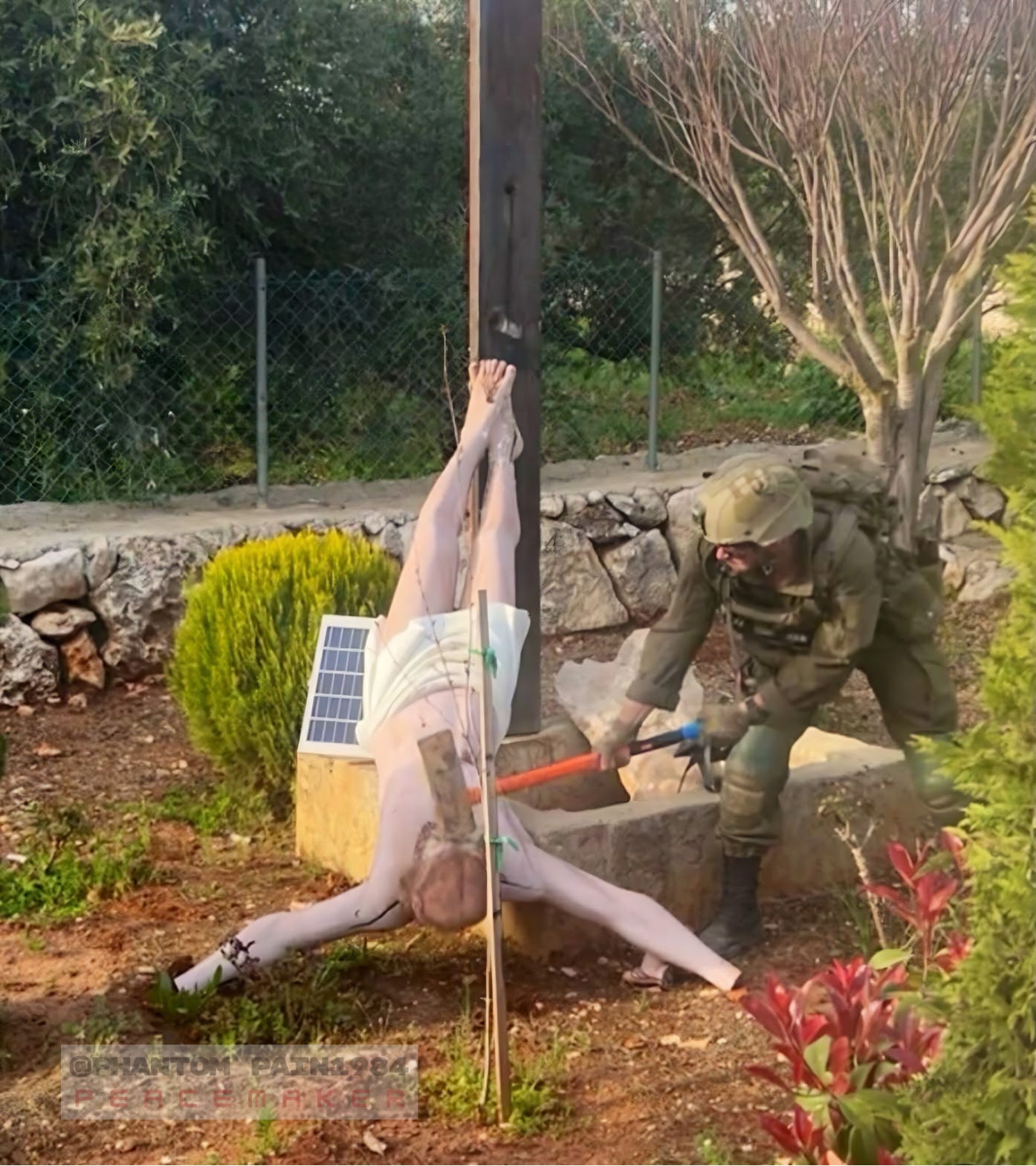 An Israeli soldier brings a hammer down on the crucified Christ in Debel, southern Lebanon. The statue stood in a Christian village until Israel arrived — a single image that collapses the lie of “Judeo-Christian” protection.