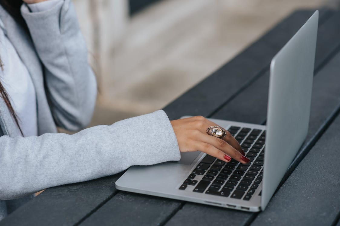 Person in Gray Long Sleeve Shirt Using Macbook Pro Person in Gray Long Sleeve Shirt Using Macbook Pro