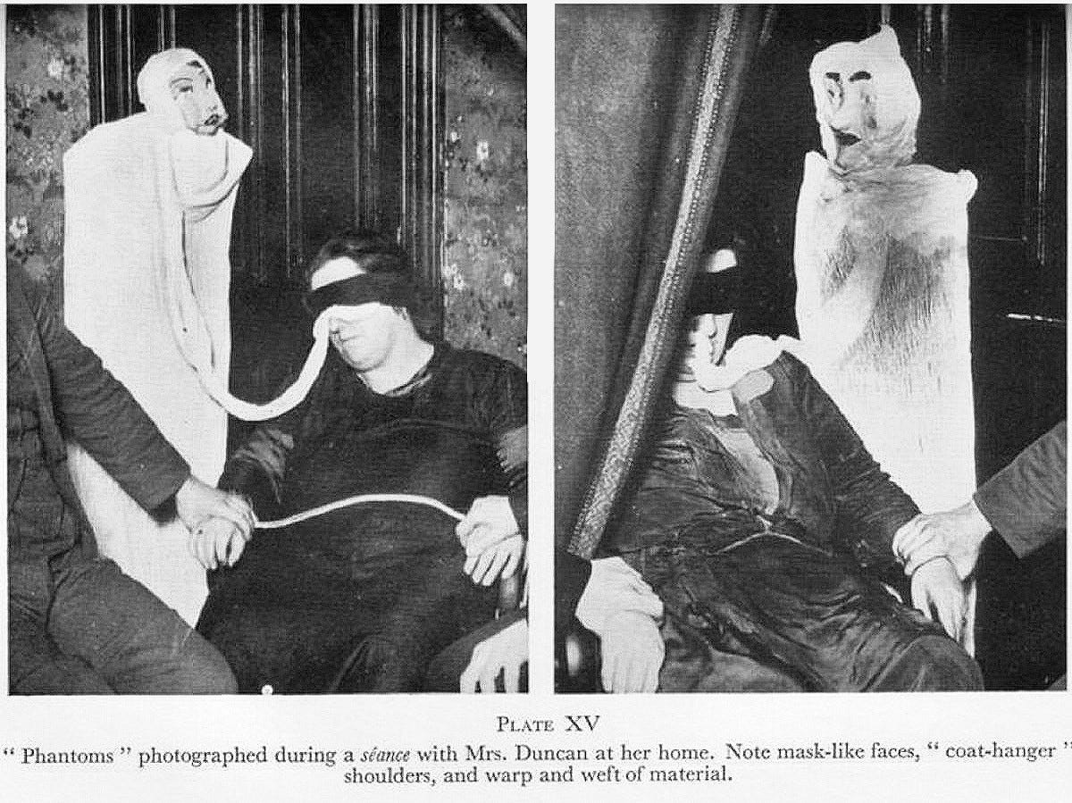 Helen Duncan pictured in 1928 with fabric emerging from her (although in one it looks like it’s coming out from under a blindfold she’s wearing) and then connecting to a freaky papier mache doll