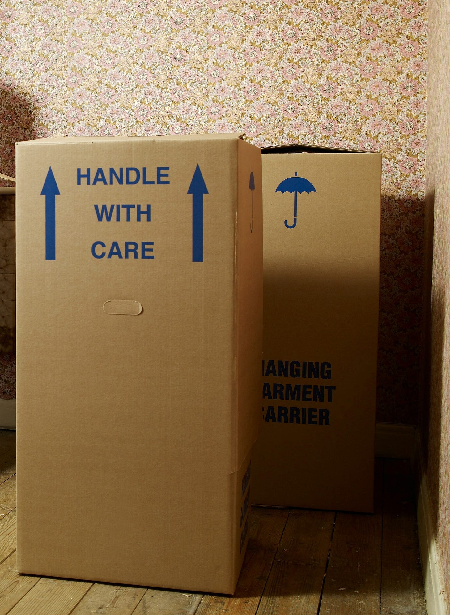 photo of moving box labeled "handle with care"