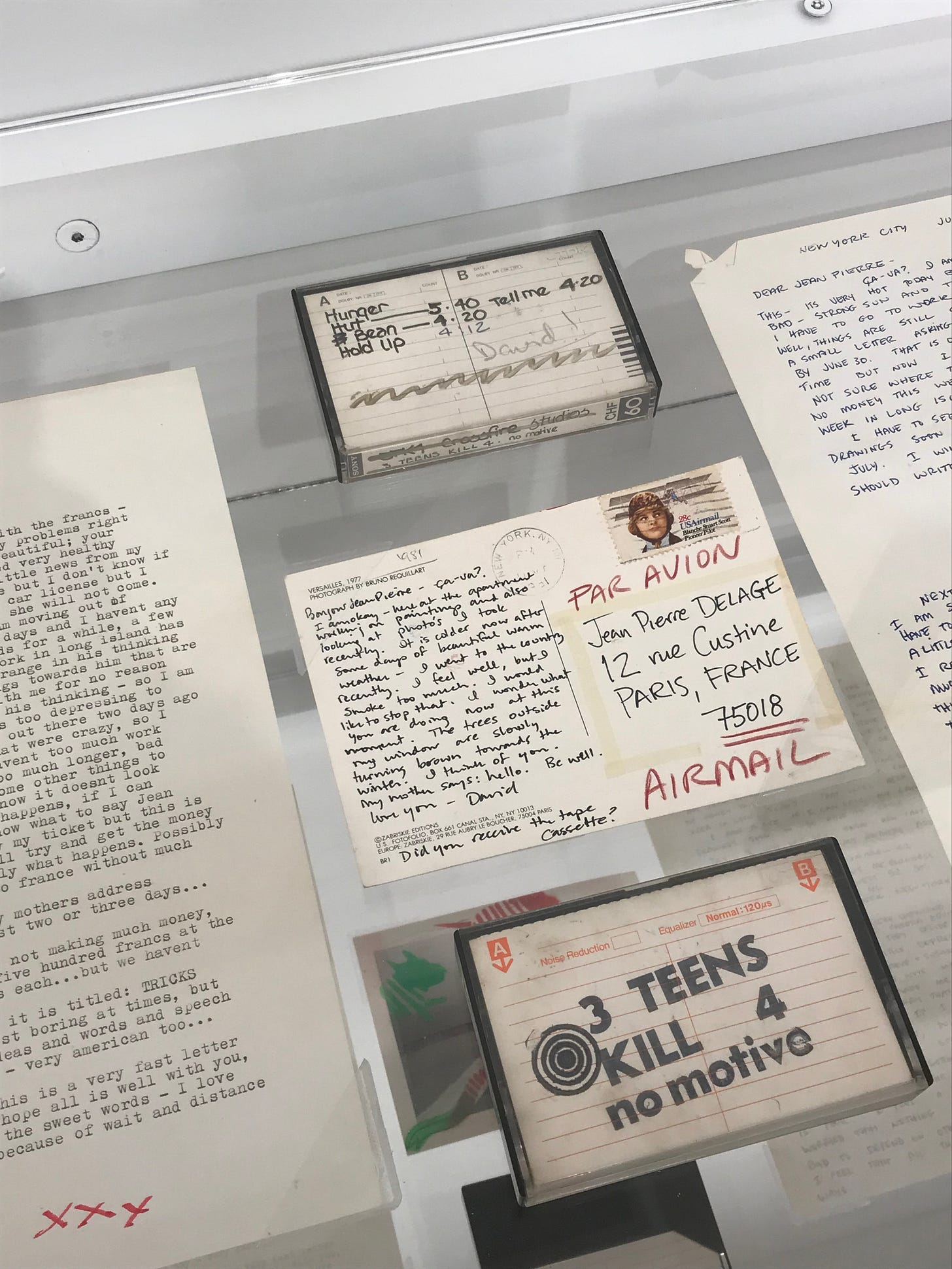 Two cassette tapes, some typescripts, and a postcard from Wojnarowicz to Delage