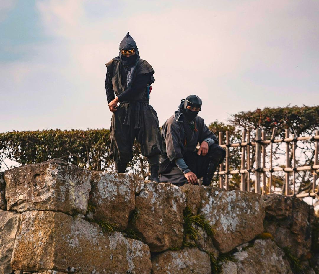 Two people sitting on a stone wall Two people sitting on a stone wall