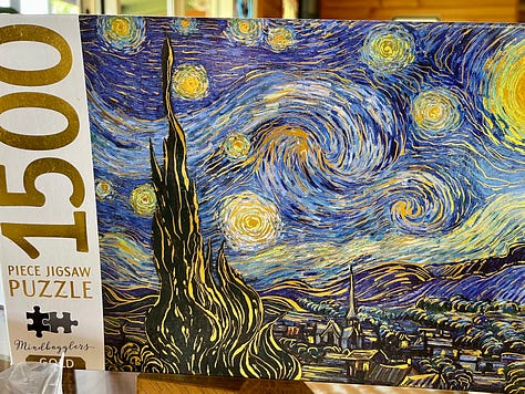 a jigsaw of the vincent van gogh painting starry starry night in various levels of completion. the final photo shows the four duplicate pieces included next to where they matched the puzzle.