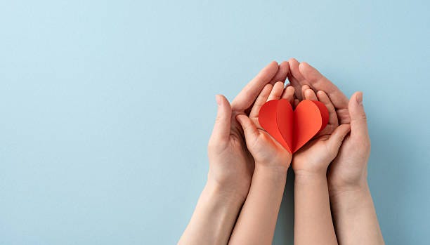Image depicting adult and child hands holding a red heart, representing love, care, and family bonds Image depicting adult and child hands holding a red heart, representing love, care, and family bonds Childcare stock pictures, royalty-free photos & images