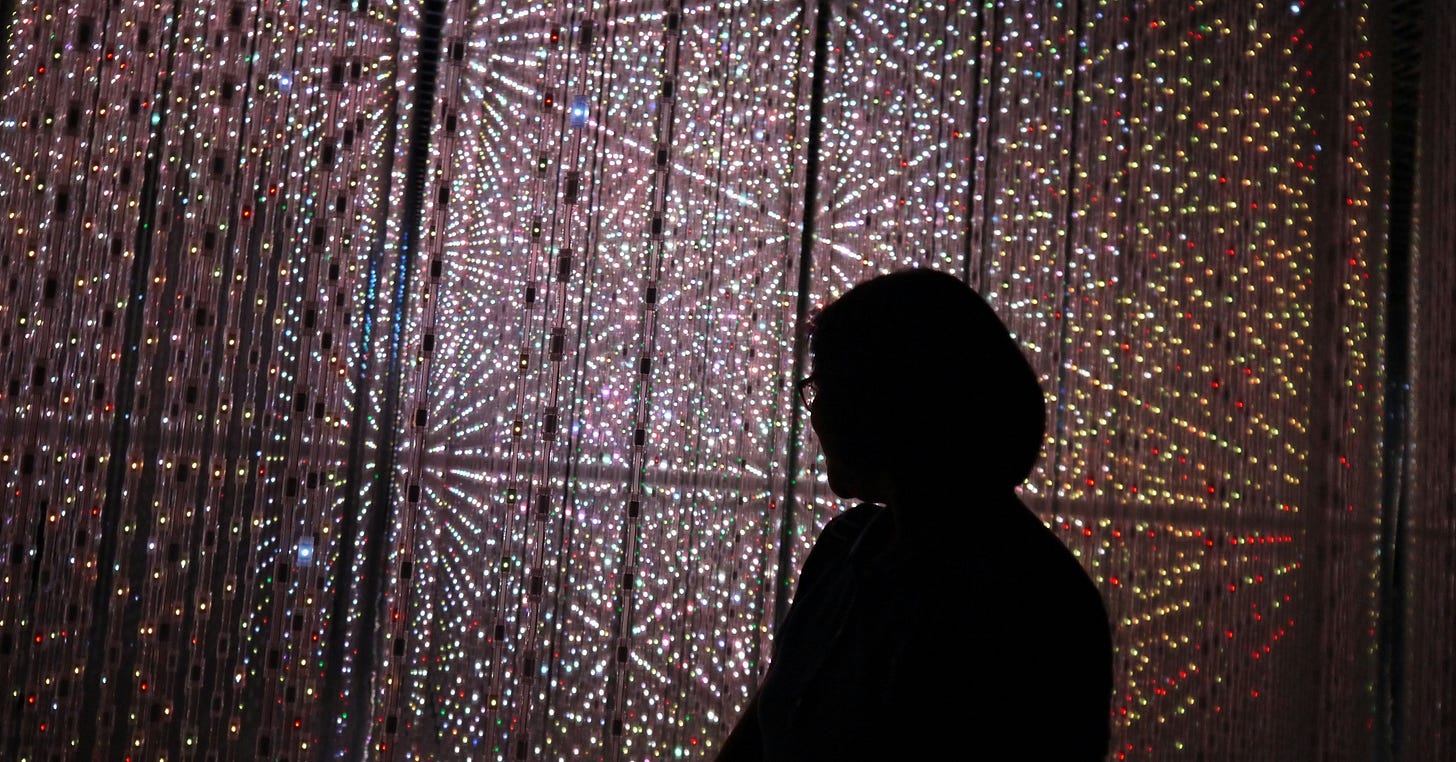 Silhouette of a person against a futuristic display