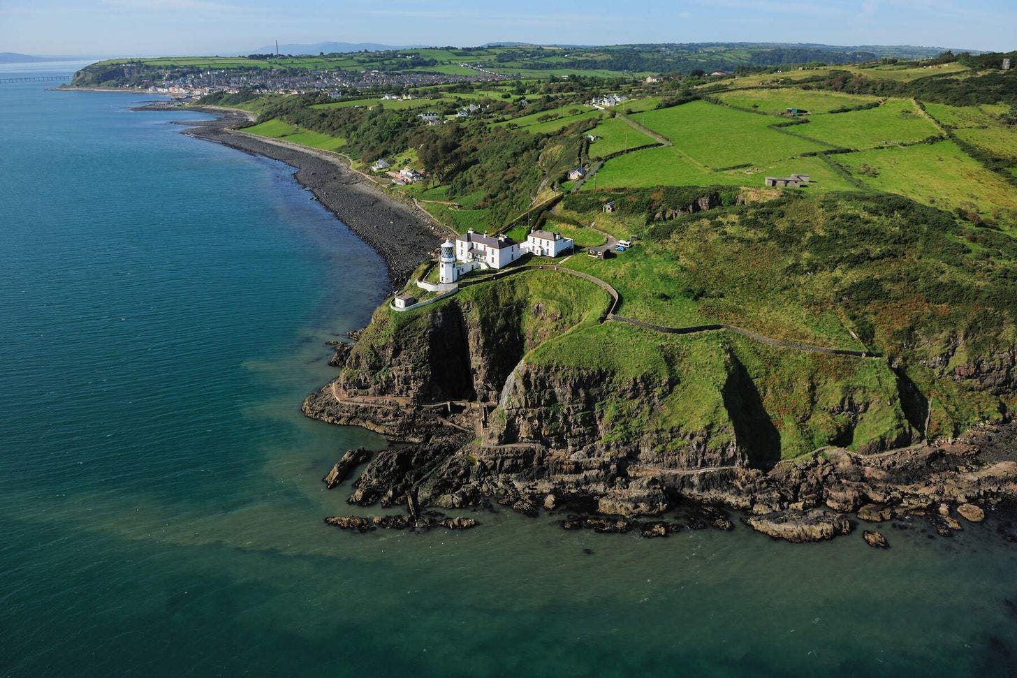 Blackhead Lighthouse perched on the cliffs of Northern Ireland overlooking the Irish Sea.
