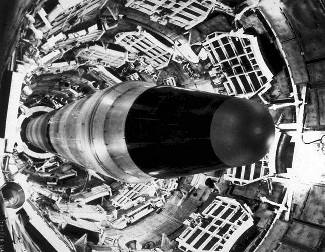 The Titan II in a complex industrial silo, surrounded by metal structures, creating a stark, mechanical mood in black and white. The Titan II in a complex industrial silo, surrounded by metal structures, creating a stark, mechanical mood in black and white.