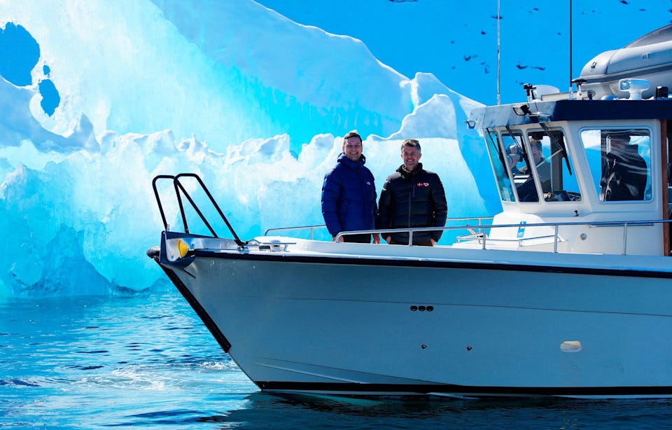 King Frederik X smiling on a boat with an ice glacier behind hem in Greeland King Frederik X smiling on a boat with an ice glacier behind hem in Greeland