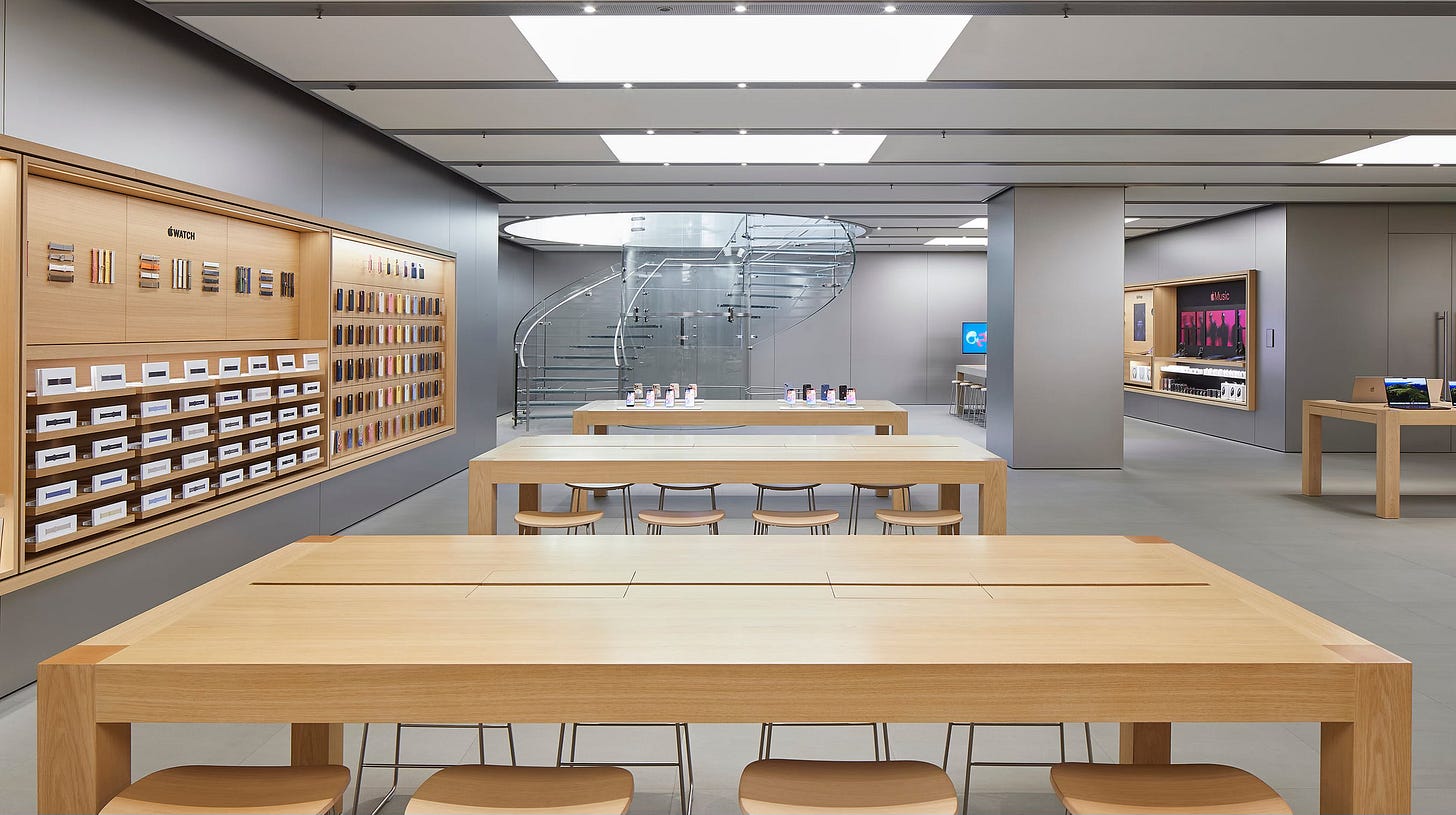 The lower level of Apple Nanjing East A glass spiral staircase is in the far end of the room.