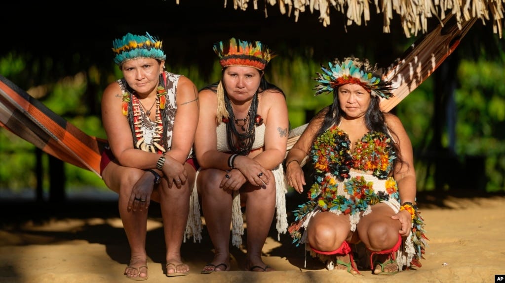 Juma Indigenous sisters Mandei Juma, from left, Mayta Juma and Borea Juma pose for a picture at their community, near Canutama, Amazonas state, Brazil, Sunday, July 9, 2023. (AP Photo/Andre Penner)