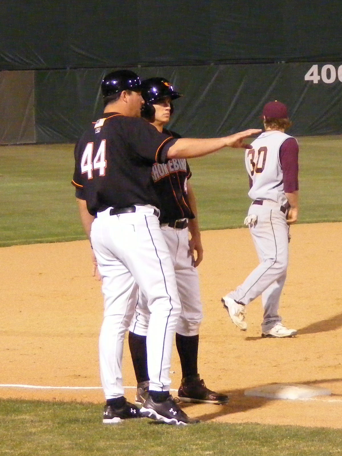 Standing at third, Mike Planeta consults with manager Ryan Minor. Photo by Kimberley Corkran. Standing at third, Mike Planeta consults with manager Ryan Minor. Photo by Kimberley Corkran.