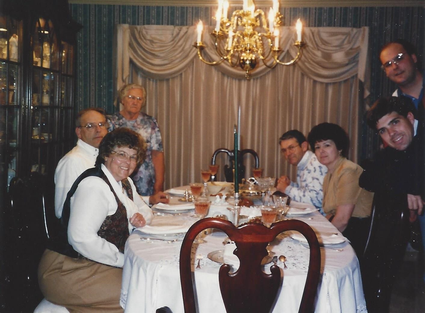 My grandmom, both sets of parents, my brother, and my husband gathered around a table set for Thanksgiving. My grandmom, both sets of parents, my brother, and my husband gathered around a table set for Thanksgiving.