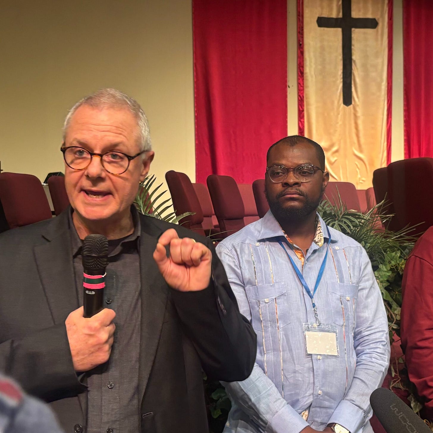 Carl Ruby, pastor of Springfield’s Central Christian Church, (right) and Viles Dorsainvil, executive director of the Haitian Support Center in Springfield, (left) speak to the media on Feb. 2, 2026. (Creative Commons Photo by Megan Henry, Ohio Capital Journal.) Carl Ruby, pastor of Springfield’s Central Christian Church, (right) and Viles Dorsainvil, executive director of the Haitian Support Center in Springfield, (left) speak to the media on Feb. 2, 2026. (Creative Commons Photo by Megan Henry, Ohio Capital Journal.)