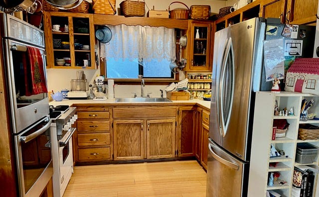 Kitchen with large ovens and large fridge,, wooden cupboards and drawers. Kitchen with large ovens and large fridge,, wooden cupboards and drawers.