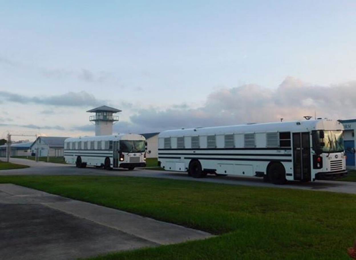Prison buses in front of a prison. Prison buses in front of a prison.