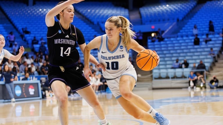 Columbia's Kitty Henderson (10) drives as Washington's Dalayah Daniels (14)...