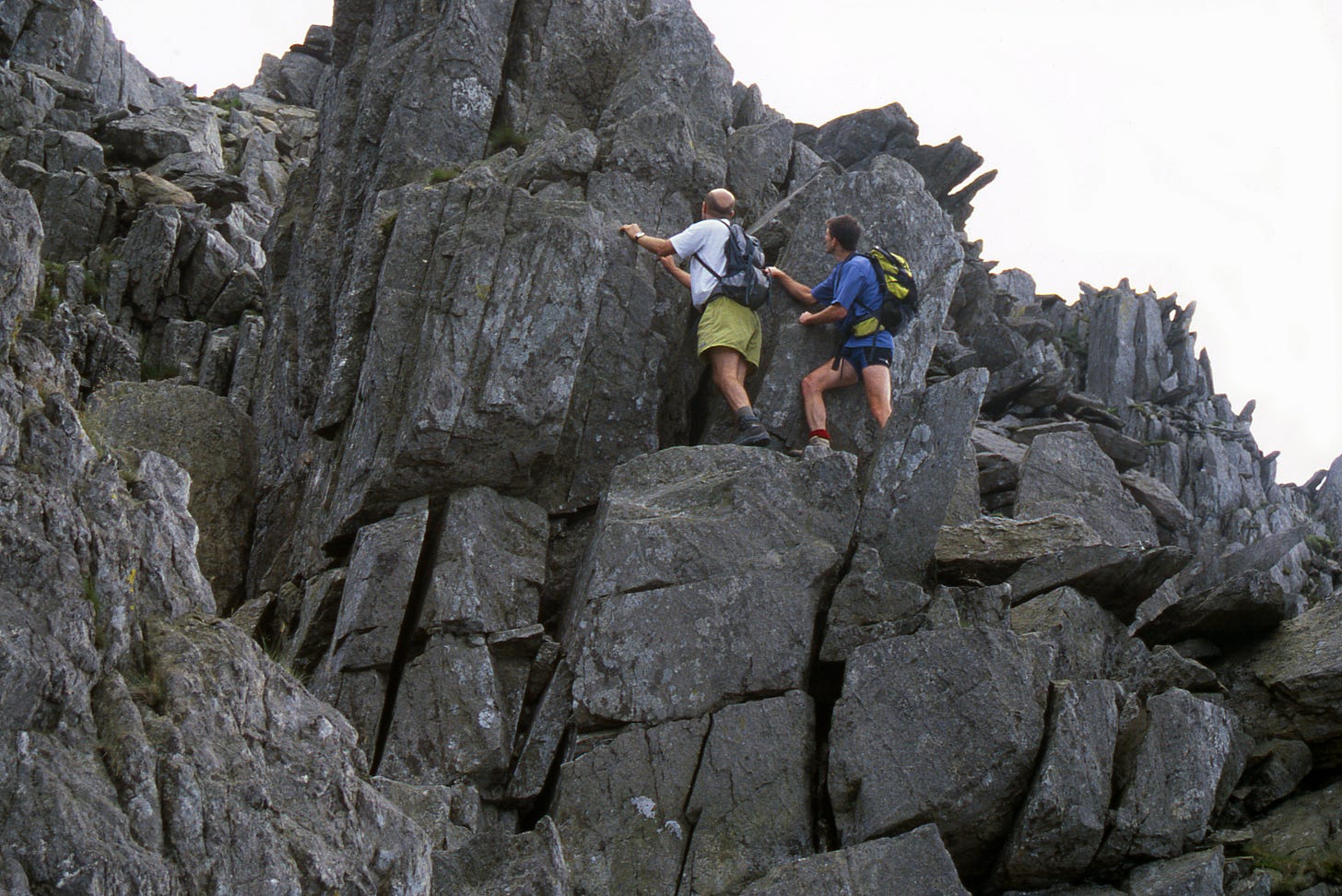 Two scramblers on grey rock tower