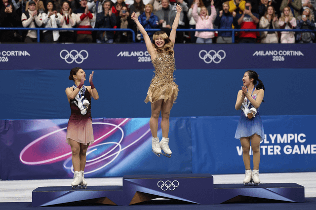 r/olympics - Alysa Liu jumps for joy on the podium (photo by Matthew Stockman for Getty)