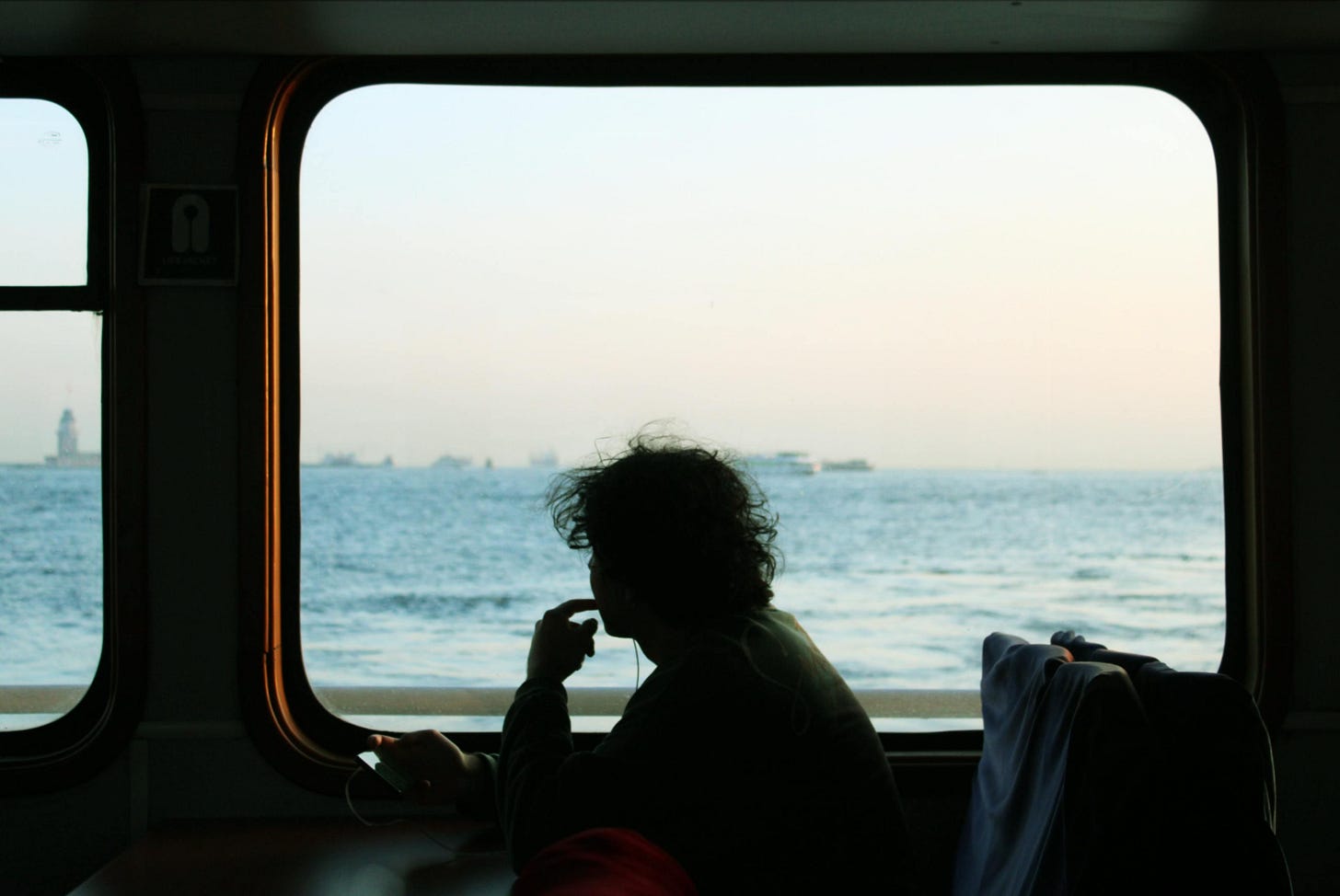 person in train with ocean view