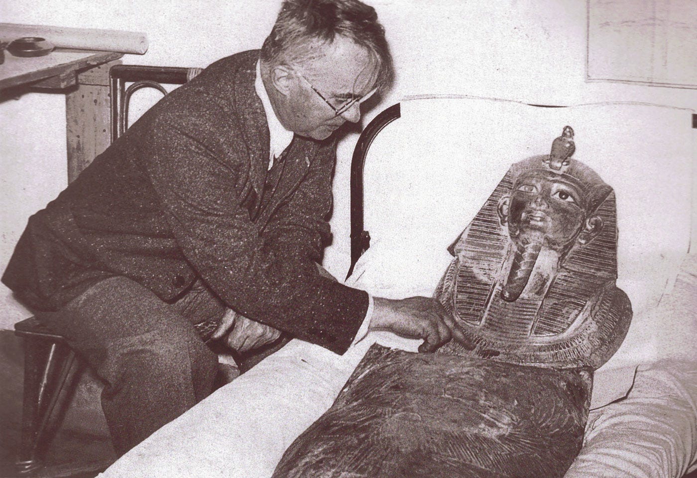 Pierre Montet inspecting Psusennes' gold mask.